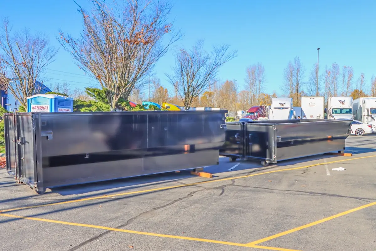 Professional dumpster rental service with roll-off container on residential driveway in Grant-Valkaria